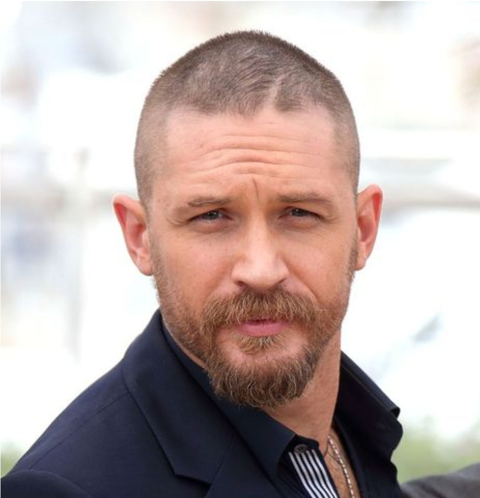 Image of a man with an oblong face sporting a buzz cut